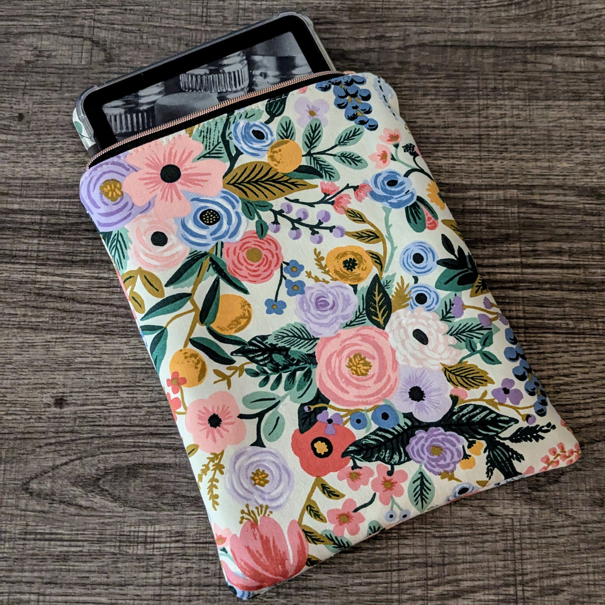 Floral-patterned case on a tablet device on a wooden surface
