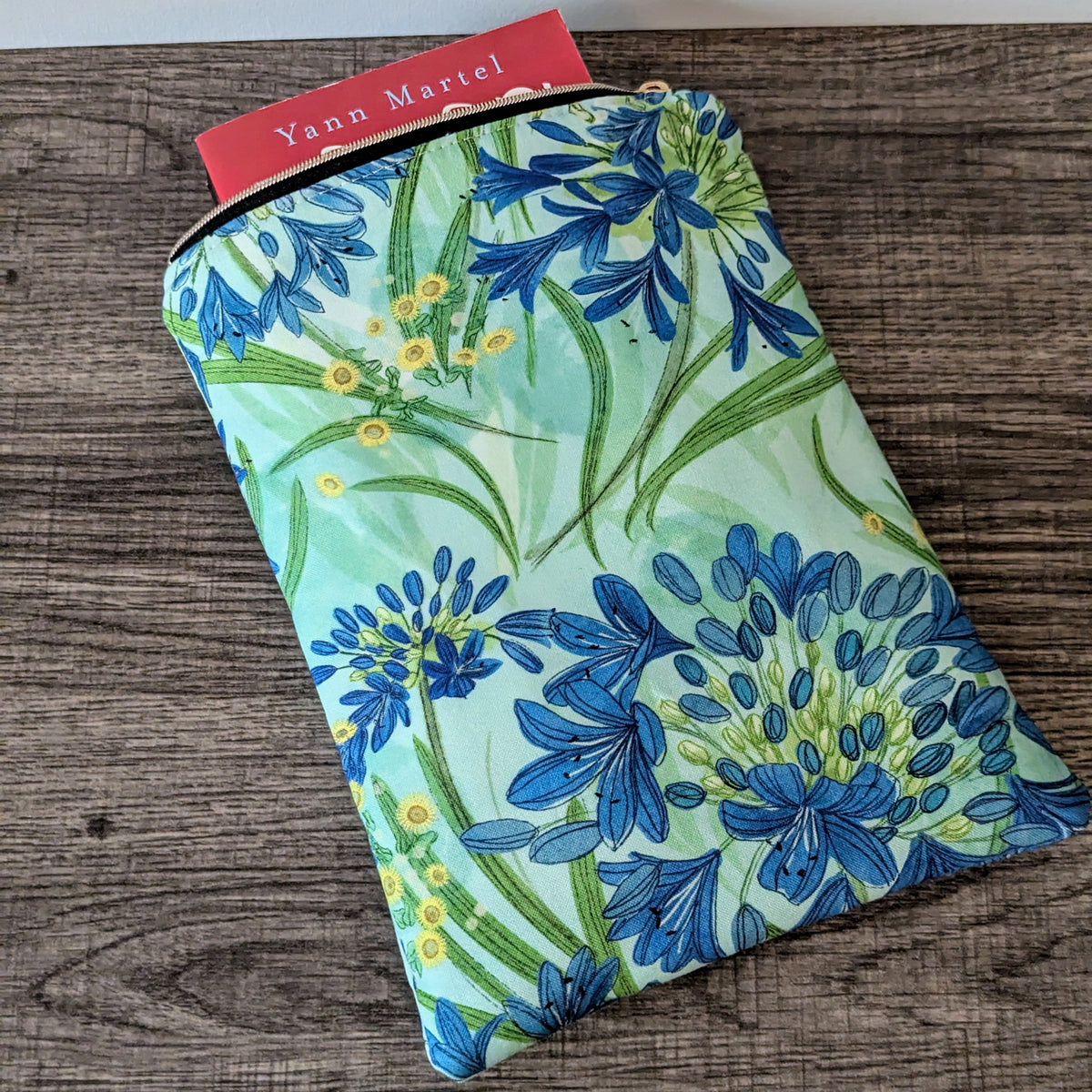 Floral-patterned product on a wooden surface with a visible brand label.