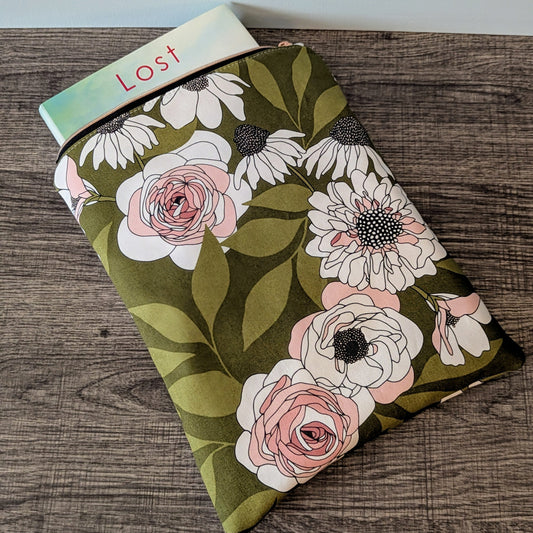 Floral notebook with a visible brand name on a wooden surface