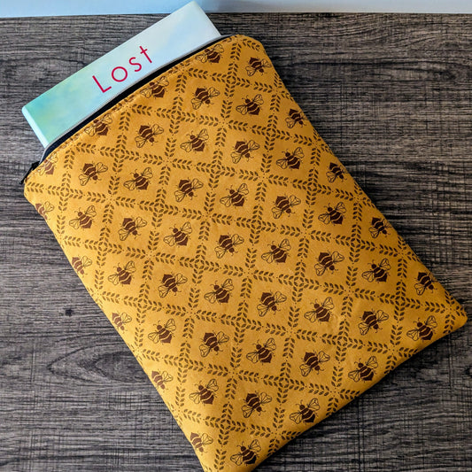 Yellow notebook with black pattern on a wooden surface