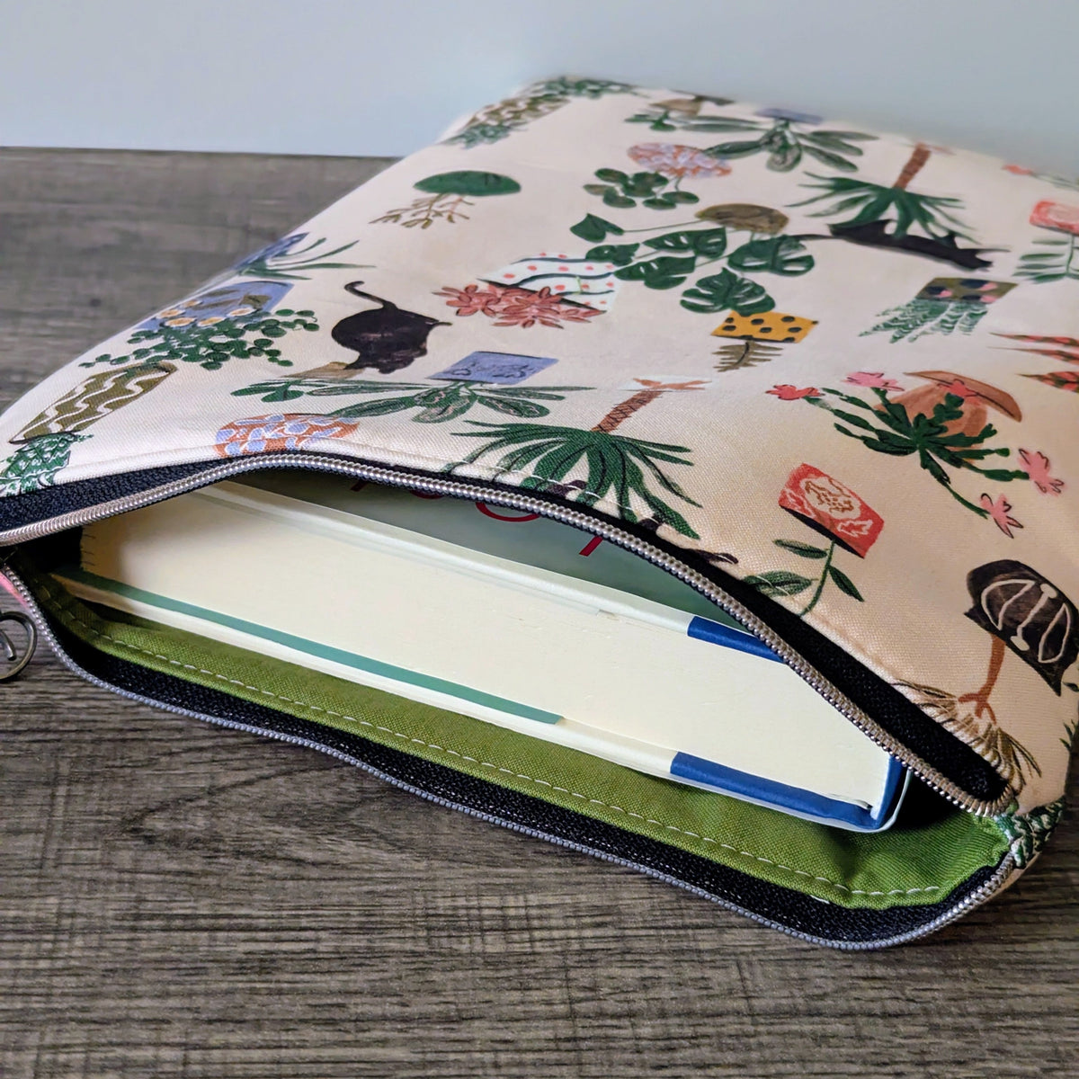 Floral-patterned pouch with a zipper on a wooden surface